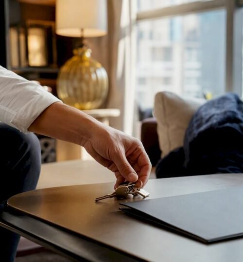 Hand placing keys on office desk