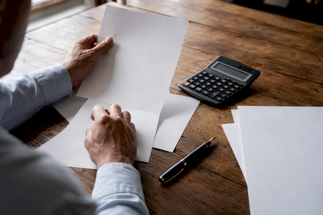 Hands with financial documents and calculator