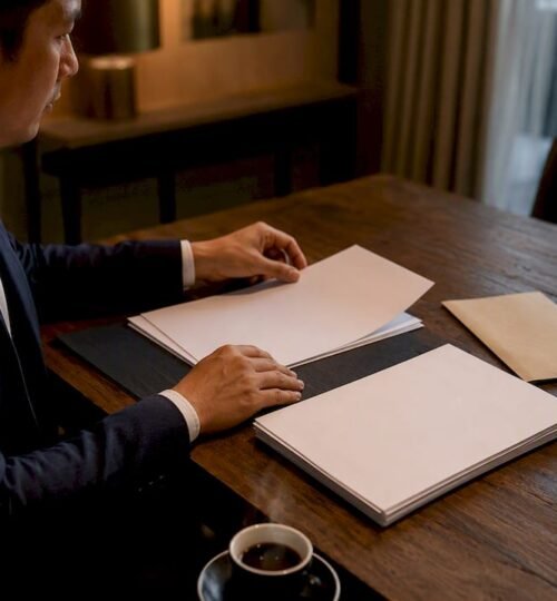 Agent arranging blank loan documents on desk